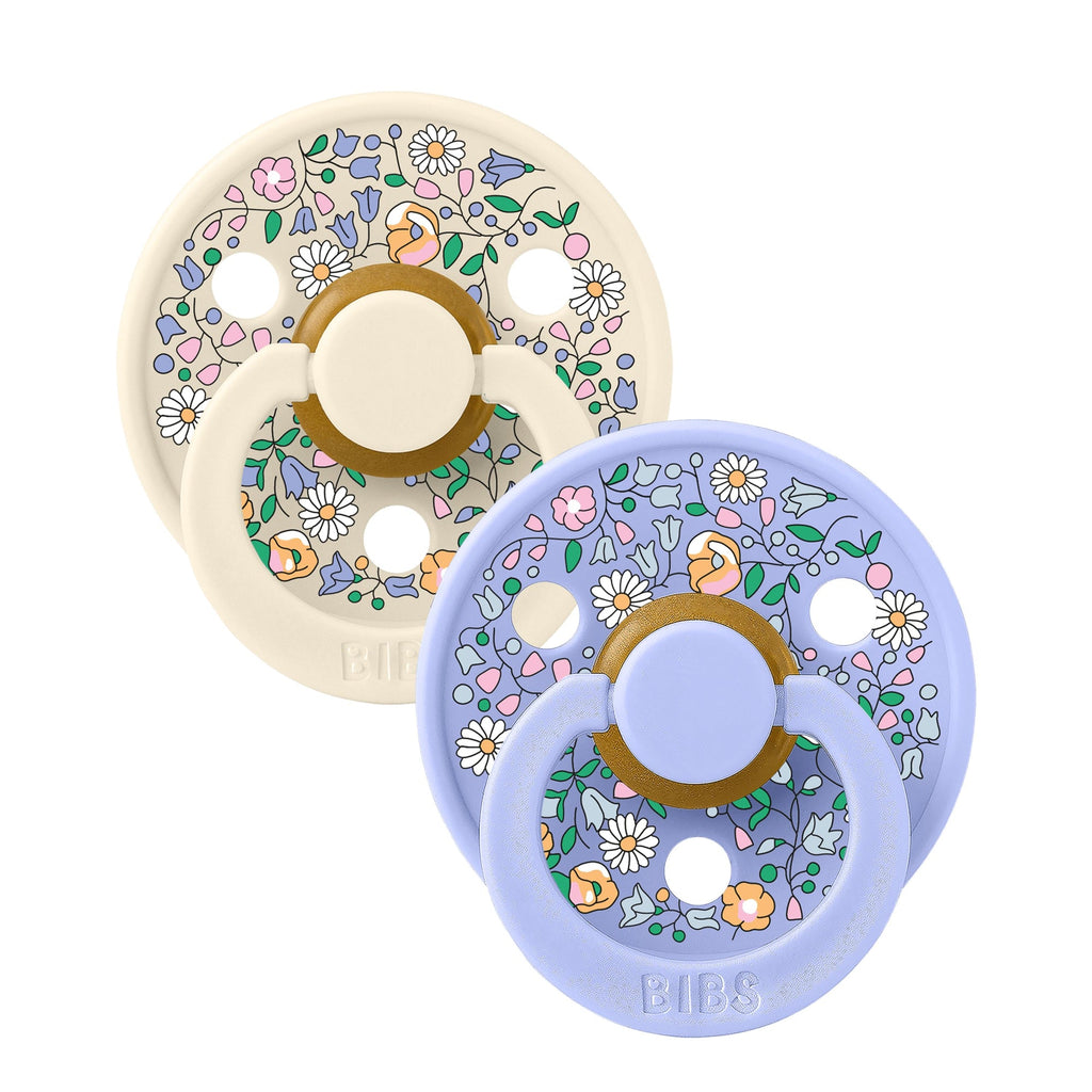 Two BIBS Liberty floral baby pacifiers sold by Meridian Baby.