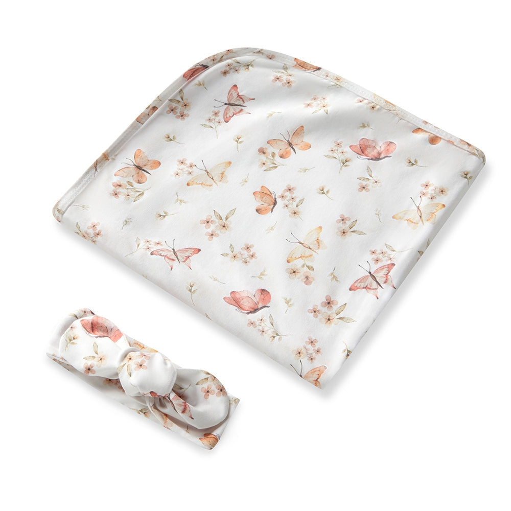 Floral-patterned baby blanket with a bow on a white background