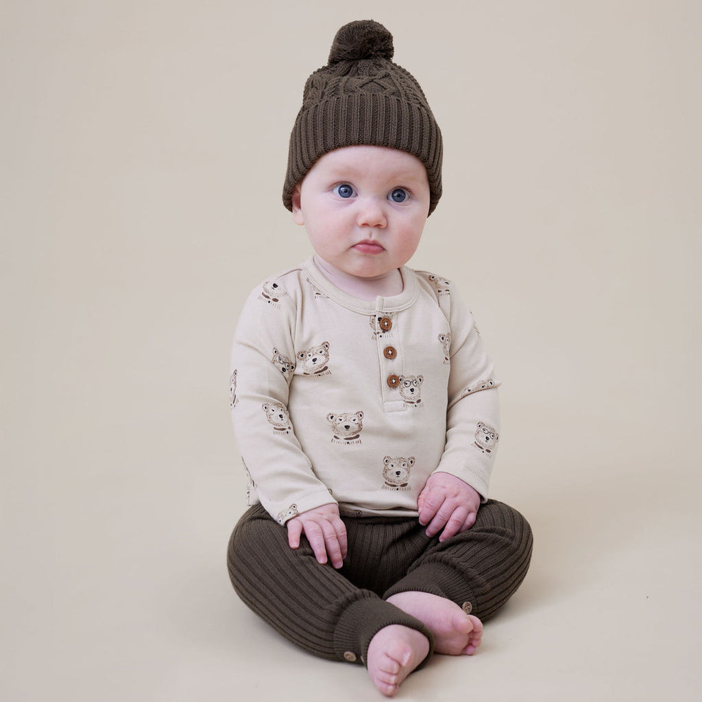 Baby boy wearing an Aster & Oak brown knit hat and matching leggings from Meridian Baby