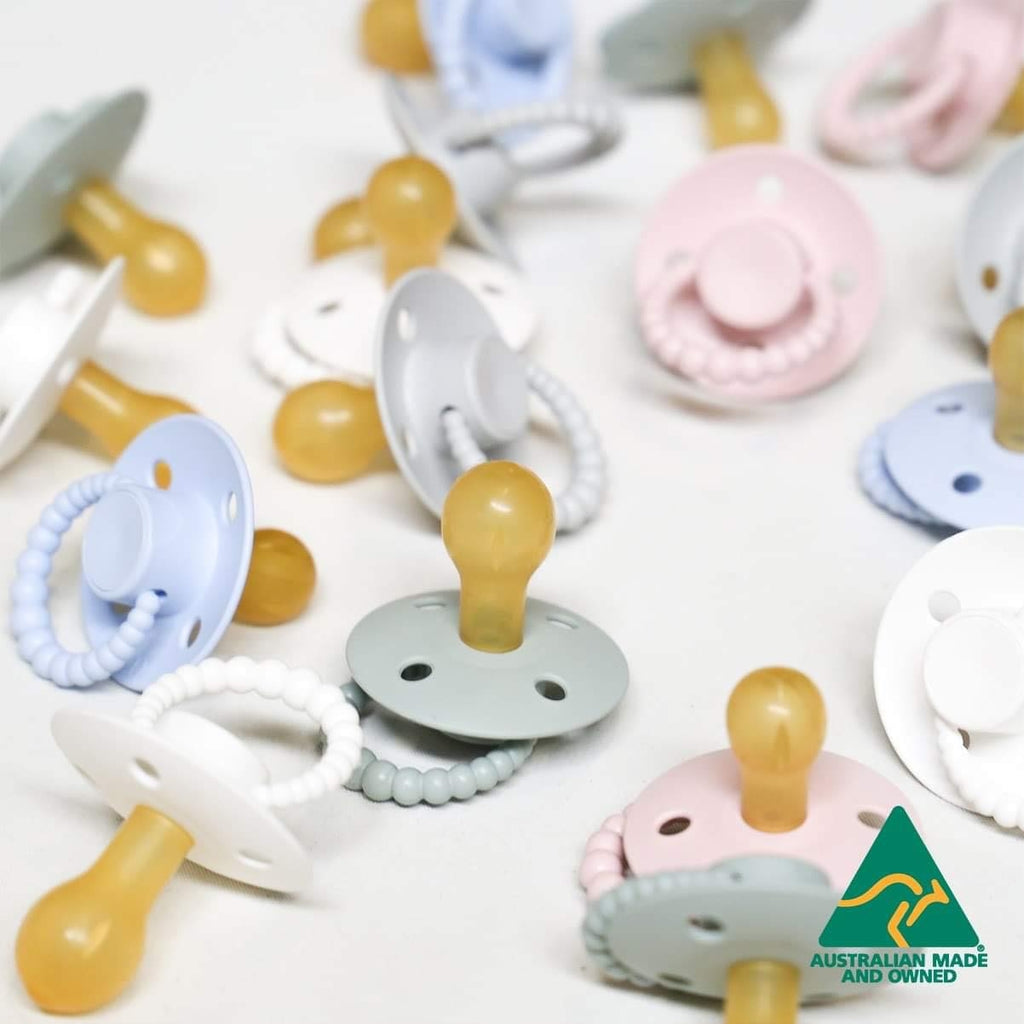 Colorful baby pacifiers on a white background with 'Australian Made and Owned' label.