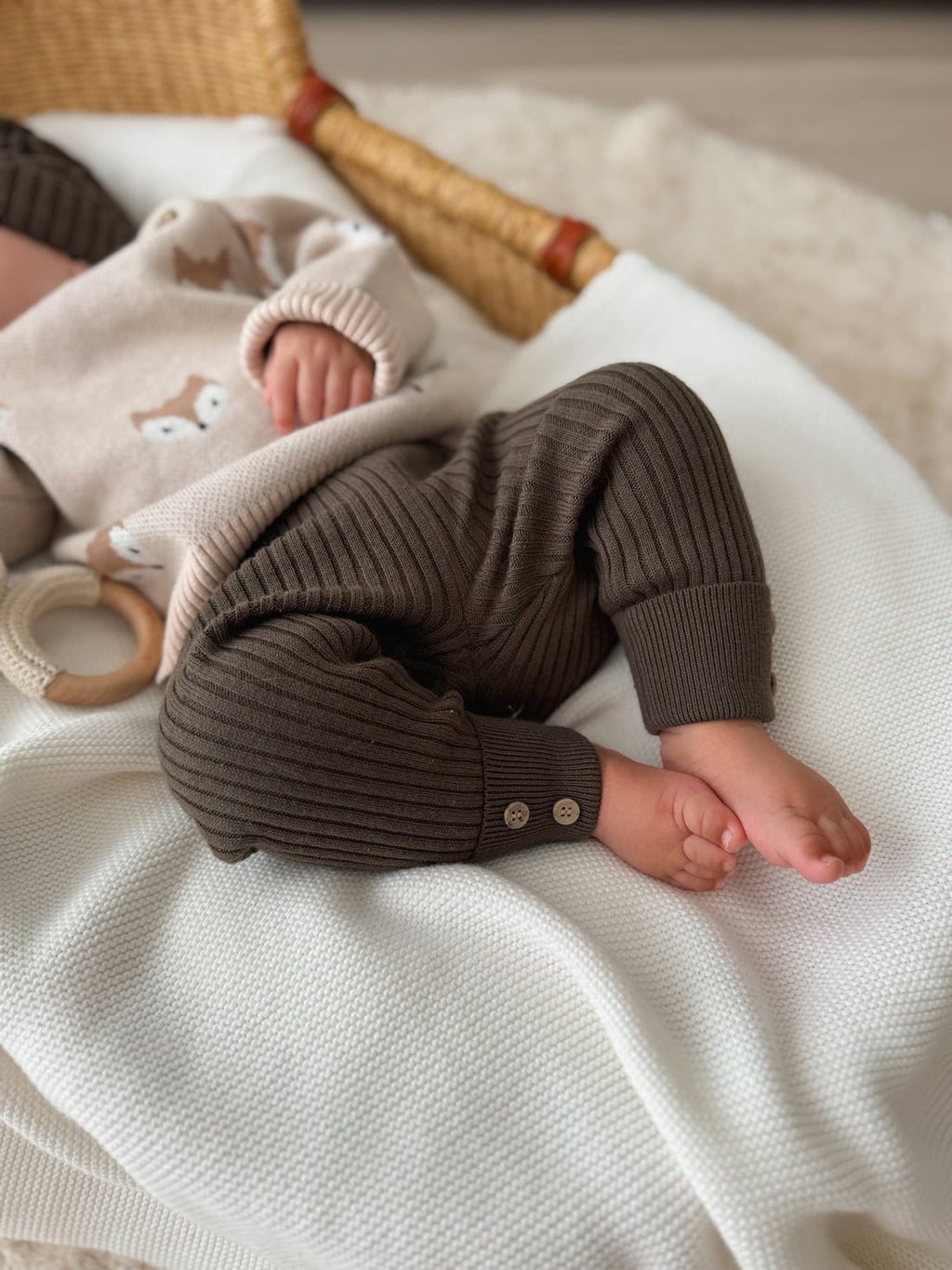 Newborn baby wearing Aster & Oak brown ribbed leggings from Meridian Baby