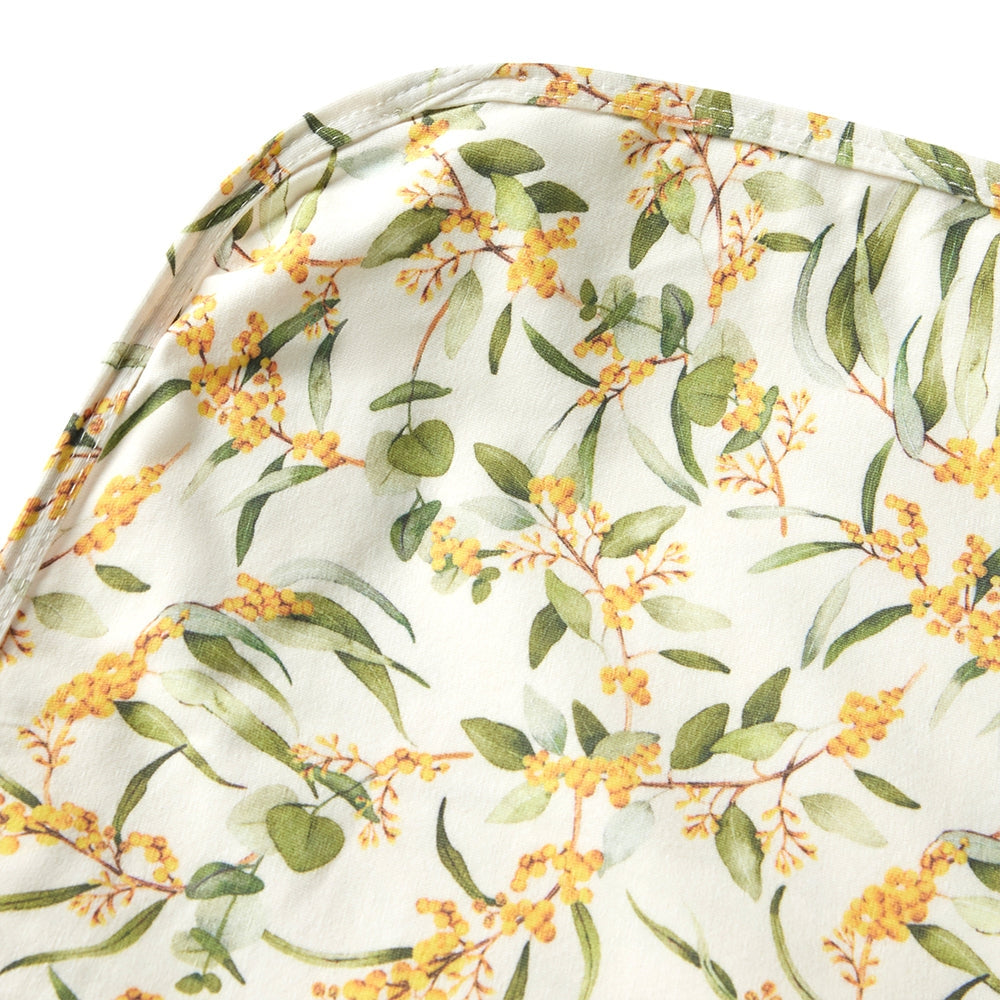 Close up view of Snuggle Hunny wrap with wattle designs from Meridian Baby.