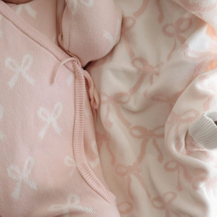 Close-up of pink baby clothing with floral patterns