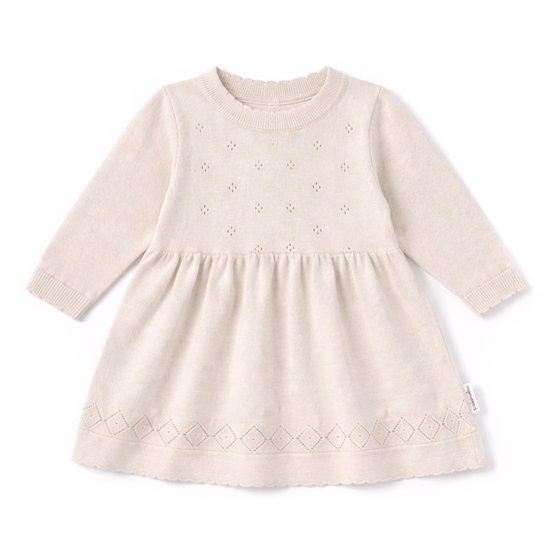 Beige baby dress with long sleeves on a white background