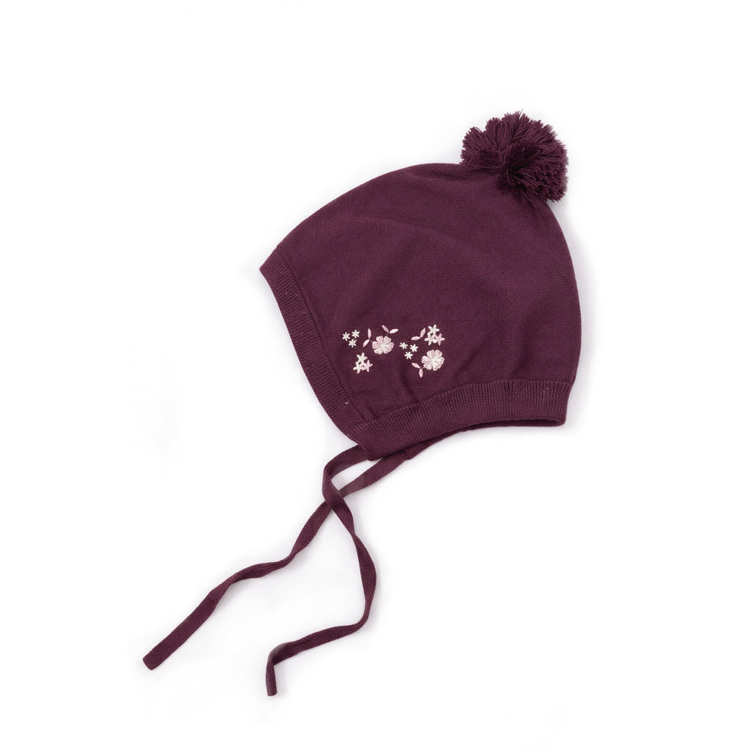Maroon knit baby hat with floral embroidery and pom-pom on a white background
