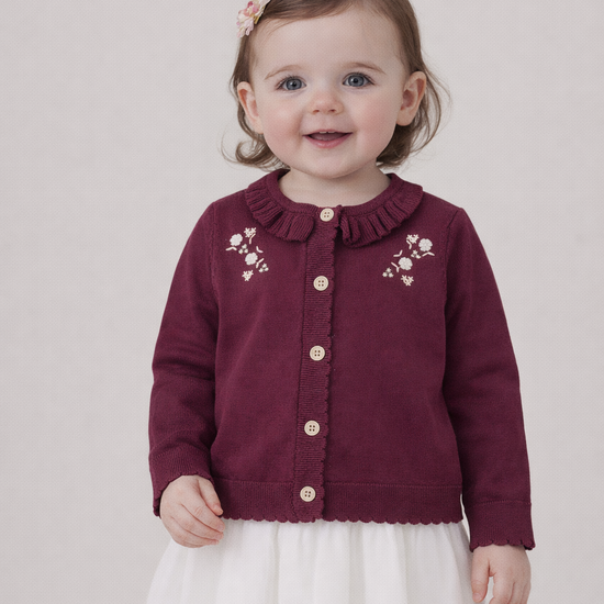 Toddler girl wearing an Aster & Oak maroon cardigan from Meridian Baby with floral embroidery