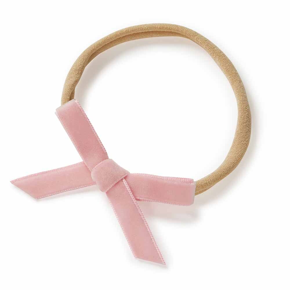 Headband with a pink velvet bow on a white background
