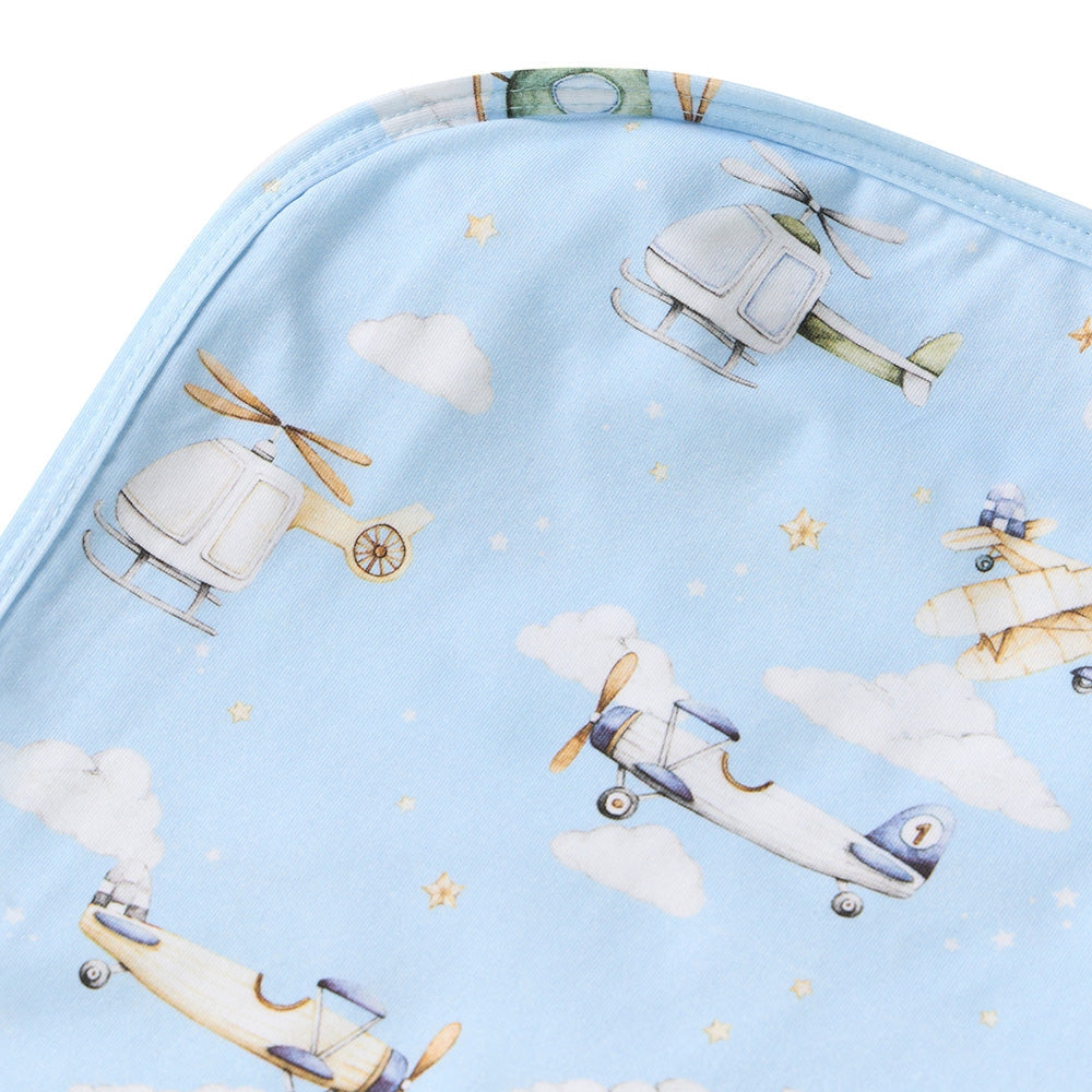 Fabric with airplane and helicopter pattern on a blue background