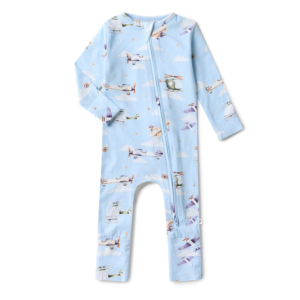 Baby onesie with airplane pattern on a light blue background