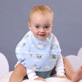 Baby boy wearing blue Snuggle Hunny feeding bib with airplane designs from Meridian Baby.